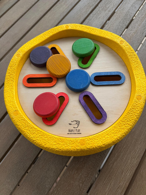 A wooden lid inside a yellow stapelstein stepping stone