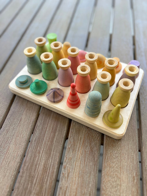 A wooden sorting/storage tray with compartments, each containing a Grapat Fancy Nins figure in various colors.