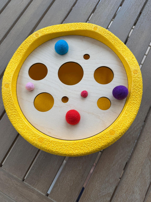 A wooden lid with holes inside Stapelstein stepping stone 