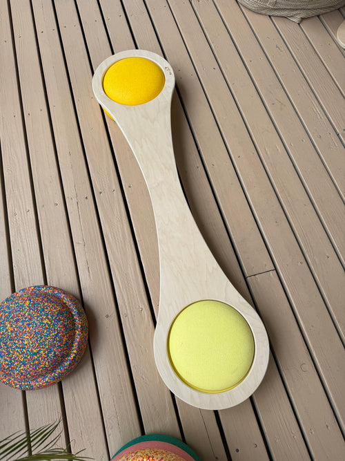 Handmade maple wood balance board for kids, flat view on wood deck