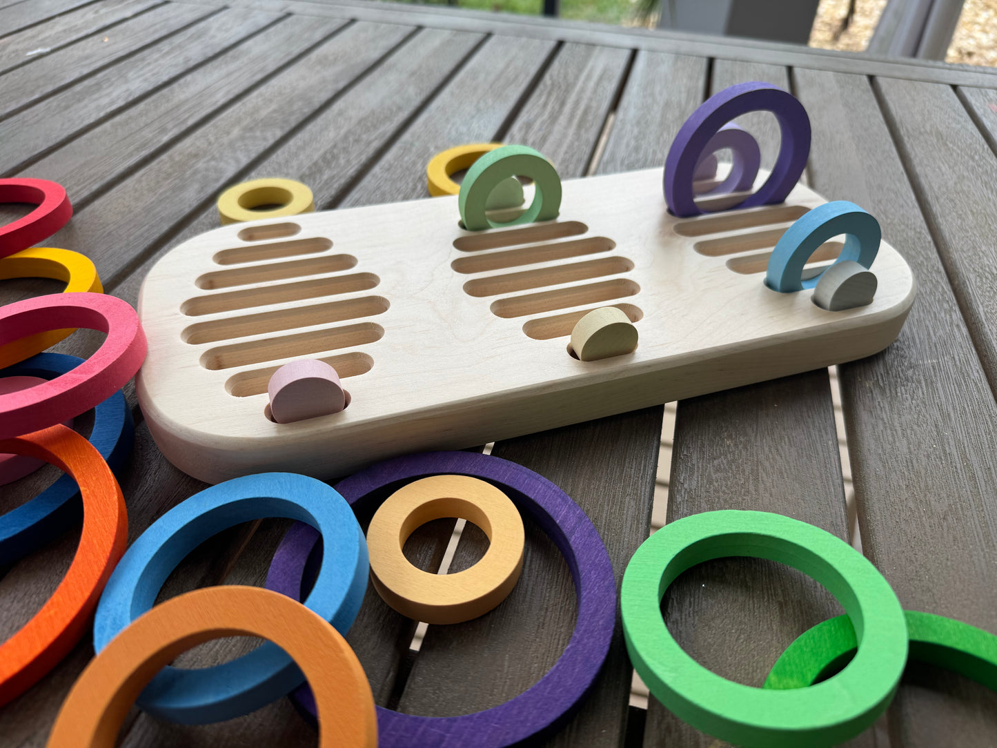 Colorful wooden rings on a wooden surface