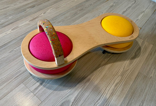 Wooden toy scooter with colorful handle and pink and yellow stepping stones