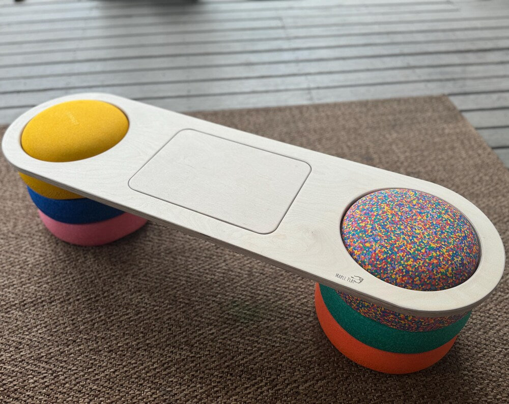 Handmade maple wood balance board for kids, on a carpet